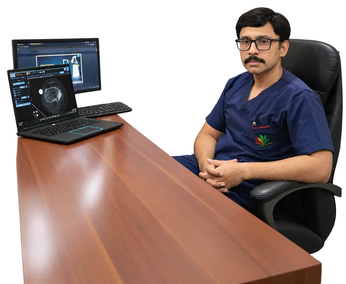 Dr. Unmesh Chakraverty reviewing a patient's imaging at his desk